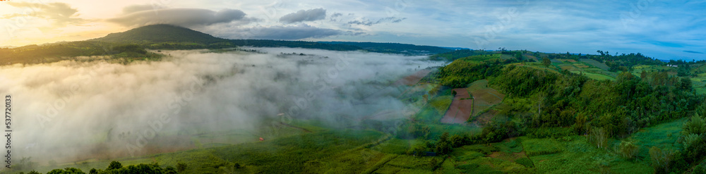 Mountains in fog at beautiful autumn in Phetchabun Thailand. Fog mountain valley, low clouds, forest, colorful sky with. pine trees in spruce foggy forest with bright sunrise Mountains in fog at beautiful autumn in Phetchabun Thailand. Fog mountain valley, low clouds, forest, colorful sky with. pine trees in spruce foggy forest with bright sunrise