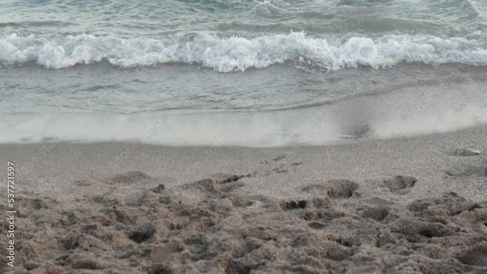 sexy slim attractive woman in swimsuit lying in water sea waves on sands beach.girl feet legs barefoot runing in ocean or walking from water on beach.summer sea vacation leisure time warm weather.back sexy slim attractive woman in swimsuit lying in water sea waves on sands beach.girl feet legs barefoot runing in ocean or walking from water on beach.summer sea vacation leisure time warm weather.back