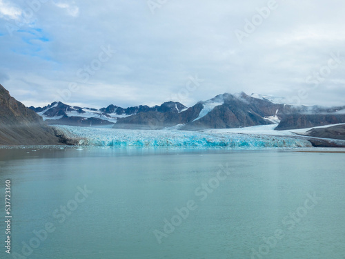Panorama view of the 14th of July Glacier or the Fjortende Julibreen. Is a beautiful glacier found in northwestern Spitsbergen. Floating Pack Ice in the arctic ocean. Dramatic sky with place for text. © familie-eisenlohr.de