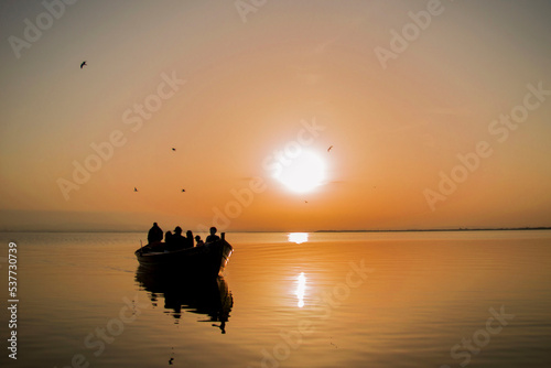 Silhouette of a small traditional boat at dusk in the Albufera in Valencia, a freshwater lagoon and estuary in Eastern Spain.