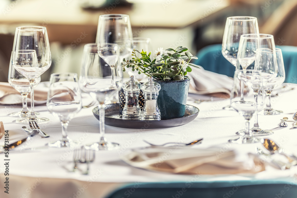 Luxury table with glasses, napkins and cutlery in restaurant or hotel Luxury table with glasses, napkins and cutlery in restaurant or hotel