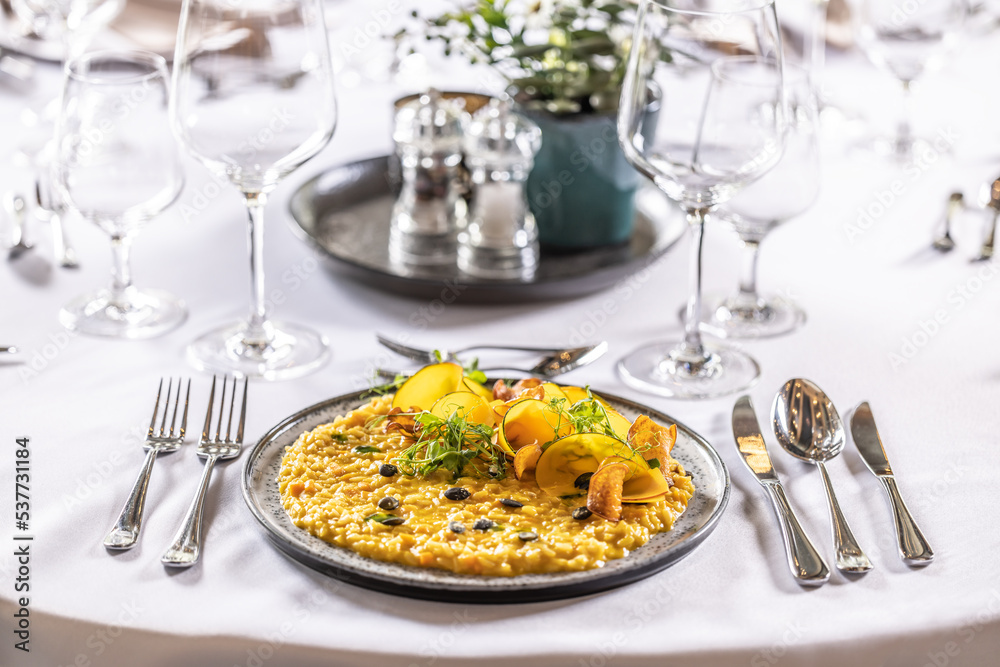 Creatively cooked pumpkin risotto served on a ceremonially prepared table in the hotel restaurant