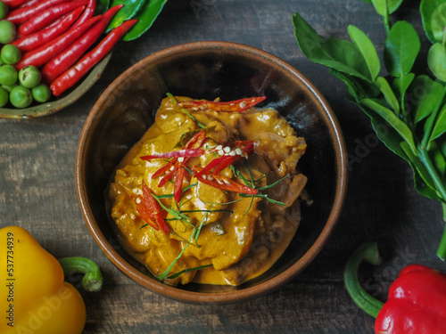 A full set of Thai food on a wood table