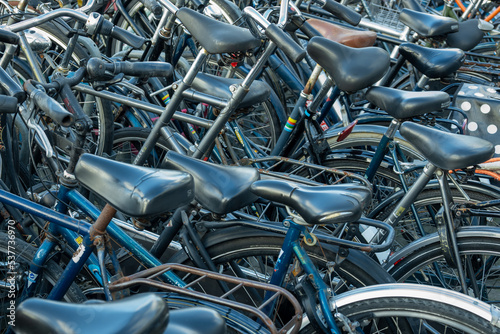 Closeup of many bicycles parked chaotically