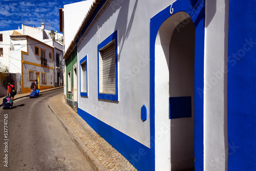 Europe, Portugal, Algarve, Faro district, Lagos, old town, Rua da Atalaia, street scene with with tourists pulling trolley suitcases