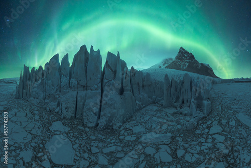 Amazing view of aurora borealis above glacier in highlands on winter day
