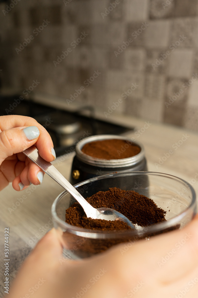 girl with a coffee pot filled with coffee with brown must to prepare traditional Italian coffee girl with a coffee pot filled with coffee with brown must to prepare traditional Italian coffee