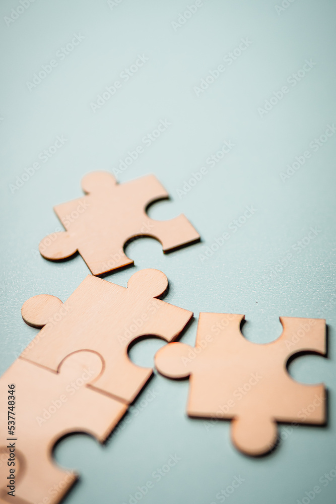 Obraz premium Wooden puzzles jigsaw solving problems in business. Innovation and teamwork in the company with copy space.