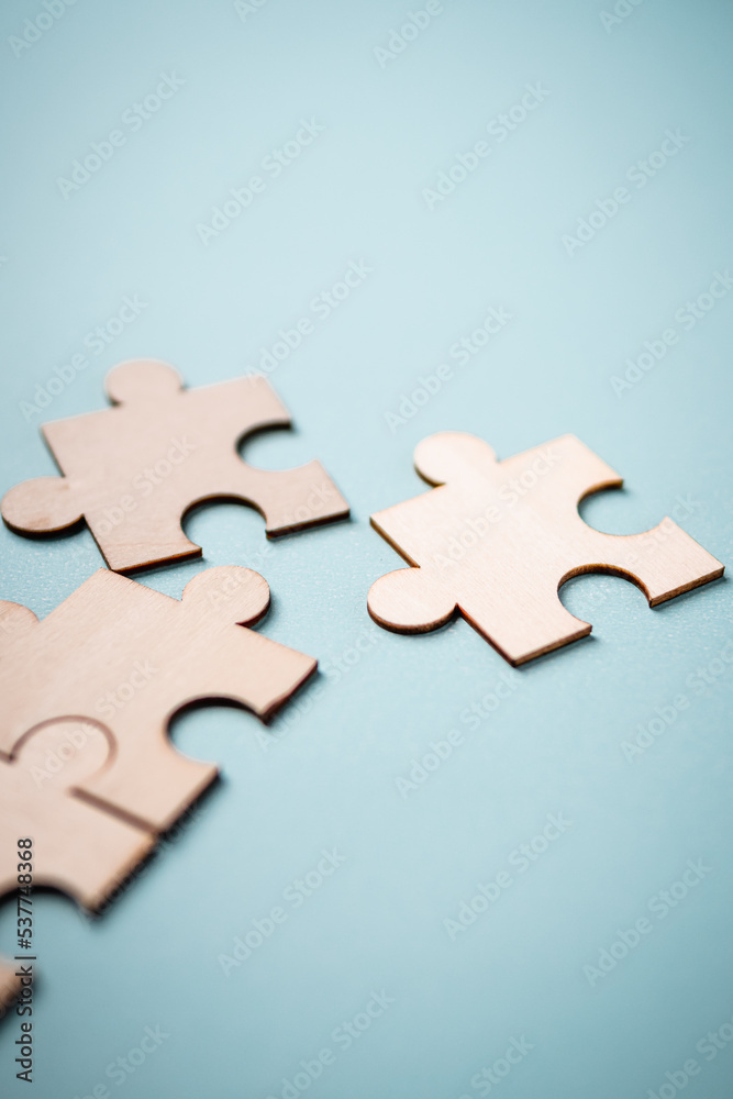 Fototapeta premium Wooden puzzles jigsaw solving problems in business. Innovation and teamwork in the company with copy space.