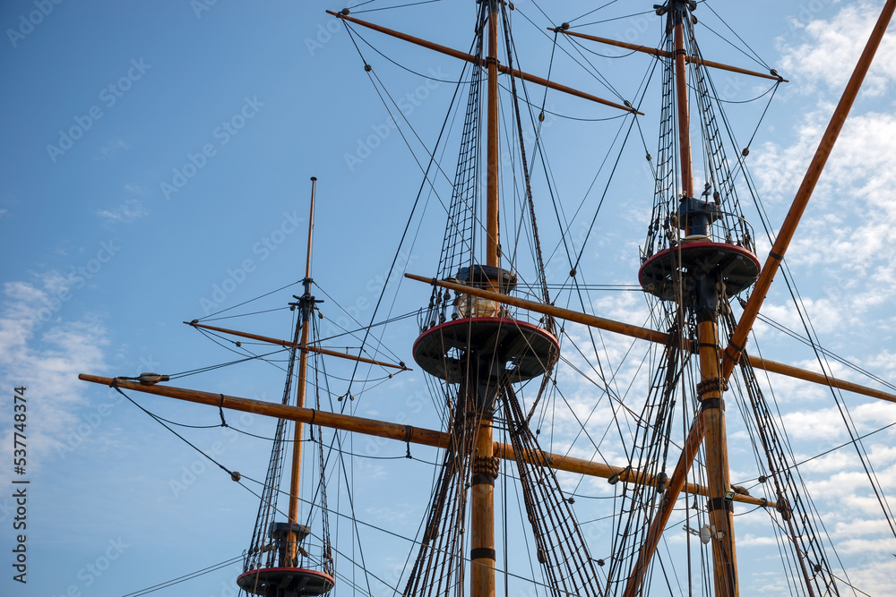 Masts, yards and rigging of sailing ship against blue sky Masts, yards and rigging of sailing ship against blue sky