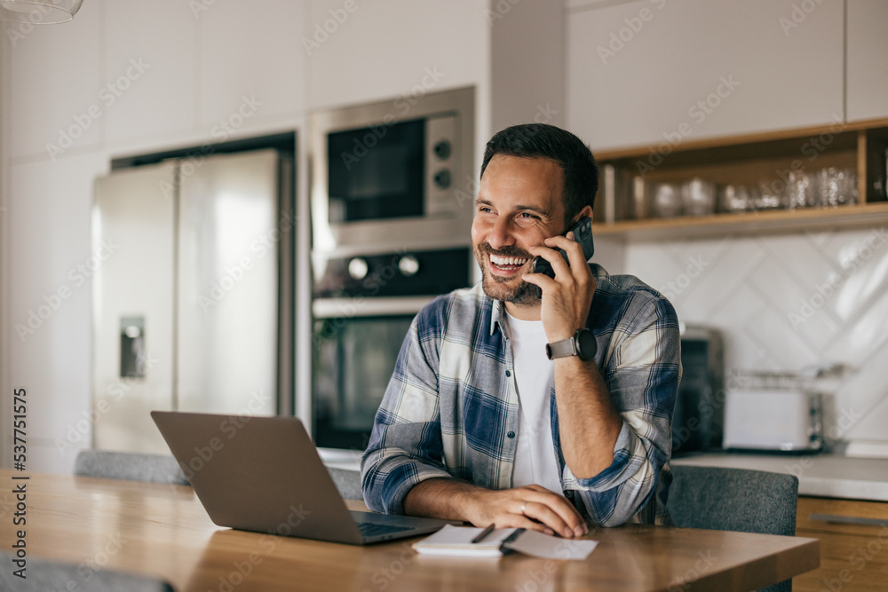 Businessman talking to someone over the phone while working over Businessman talking to someone over the phone while working over