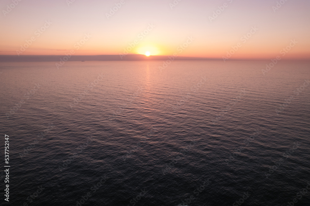 Sun setting over sea water
