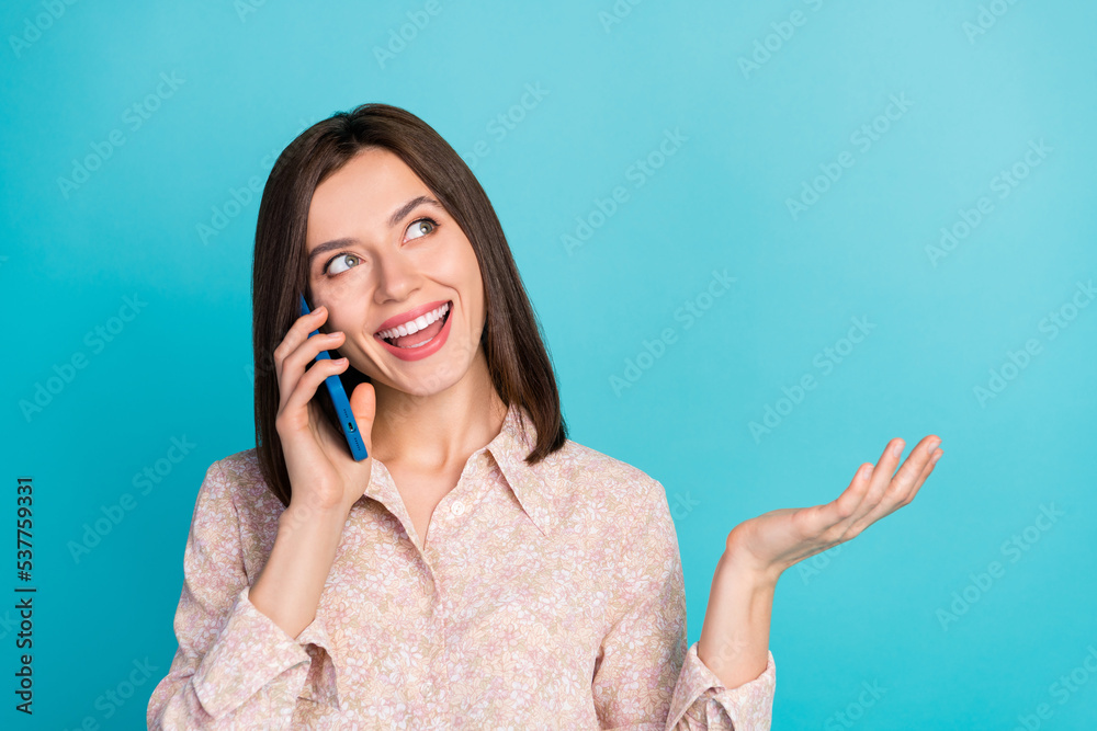 Close up photo of positive pretty lady stylish blouse interested look up empty space speak telephone app isolated on cyan color background Close up photo of positive pretty lady stylish blouse interested look up empty space speak telephone app isolated on cyan color background