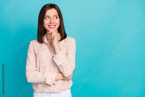 Photo of cute positive lady dressed trendy blouse interested look empty space imagine shopping sale isolated on cyan color background
