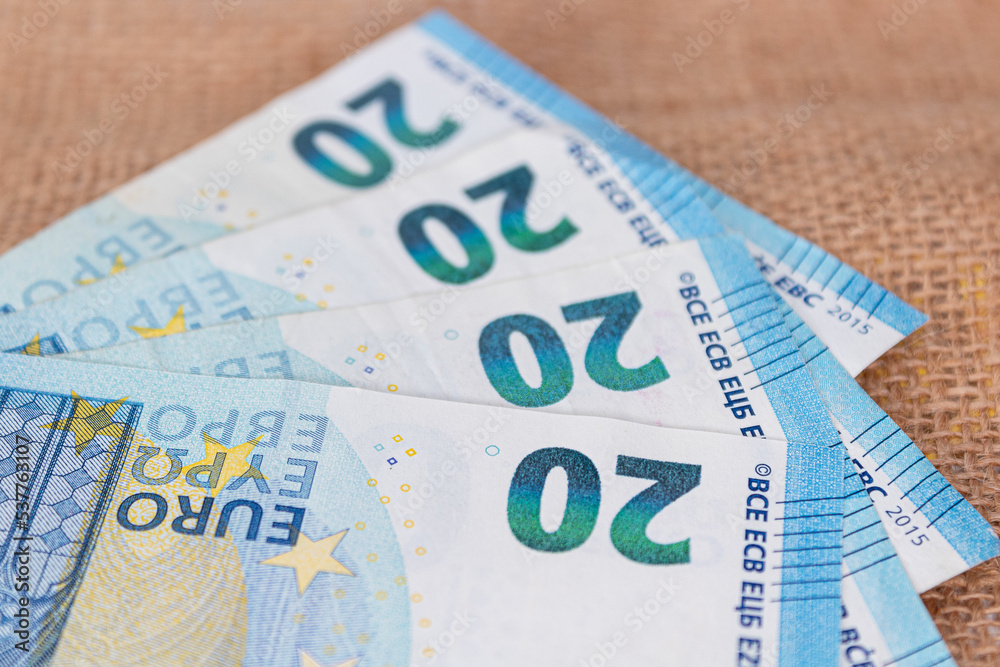 Four european twenty euro bank notes isolated on a natural background Four european twenty euro bank notes isolated on a natural background