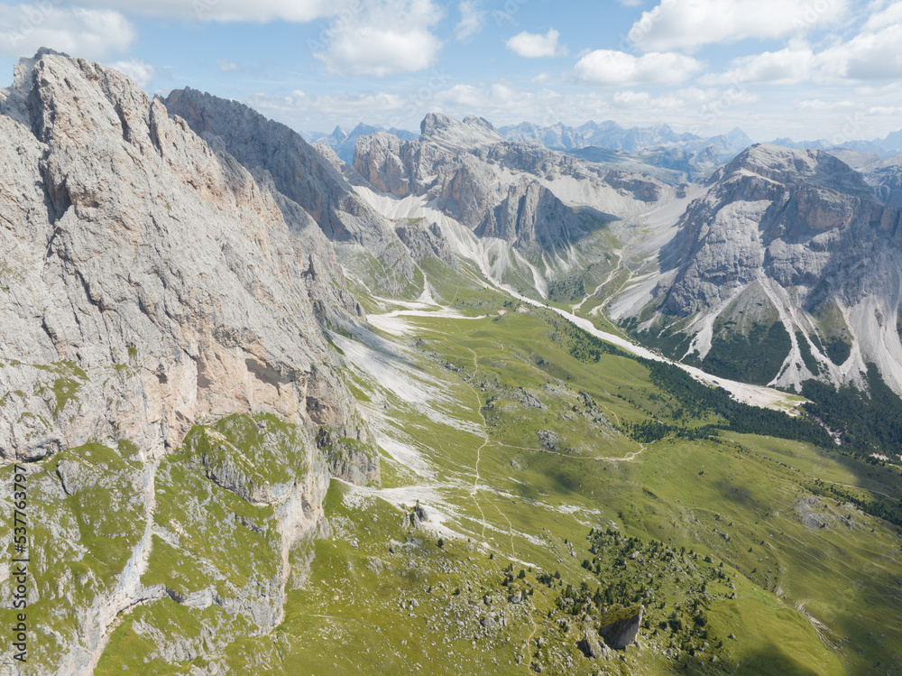 Dolomite Mountains, Dolomite Alps or Dolomitic Alps, are a mountain range located in northeastern Italy. Unesco world heritage. limestone alps grassland and cliff nature aerial drone overhead view.