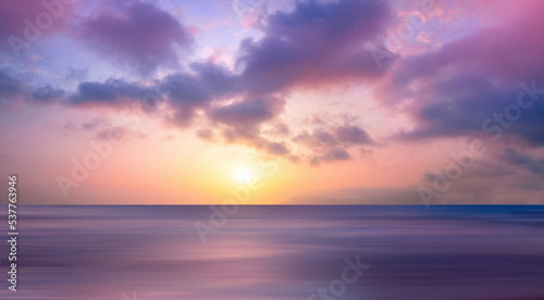 Beautiful wide format background image of marine nature at sunset on a summer day with original purple tinting.