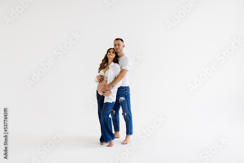 Young pregnant woman with husband isolated on white background