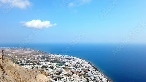 Greece, the island of Santorini. Mesa Vouno mountain. View of Kamari resort and black, volcanic beach. Runway in the background. photo