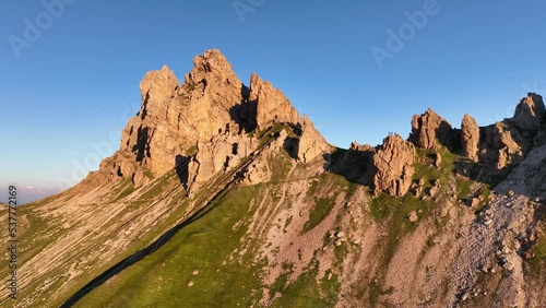 Aerial video of the sunrise in the Dolomites mountains. It was shot on the beautiful meadows of Seiser Alm plateau with fog and mist in the morning. photo