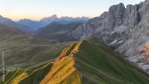 Aerial video of the sunrise in the Dolomites mountains. It was shot on the beautiful meadows of Seiser Alm plateau with fog and mist in the morning. Epic landscape in European Alps wanderlust. photo