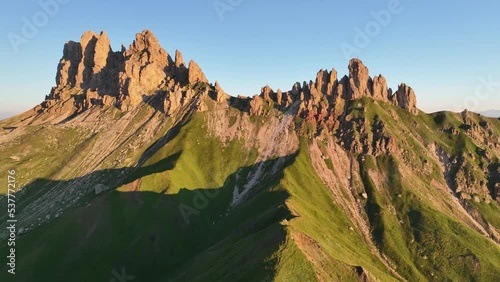 Aerial video of the sunrise in the Dolomites mountains. It was shot on the beautiful meadows of Seiser Alm plateau with fog and mist in the morning. Epic landscape in European Alps wanderlust. photo