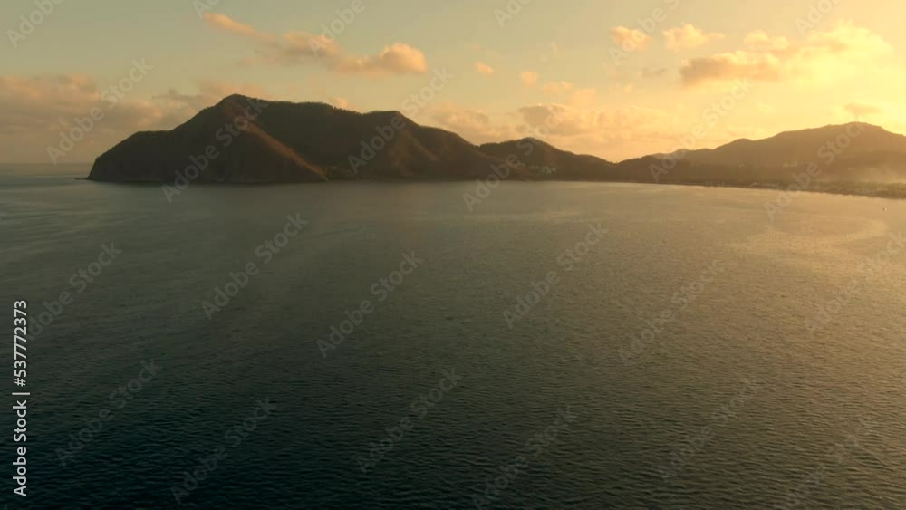 Calm Waters Of North Pacific Ocean During Golden Hour In Manzanillo Coast In Mexico. - aerial tilt up Calm Waters Of North Pacific Ocean During Golden Hour In Manzanillo Coast In Mexico. - aerial tilt up