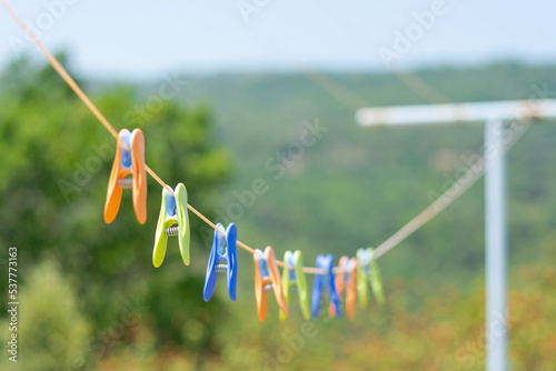 Colored clothespins hang on a rope at a mountain landscape, Pyrenees, France