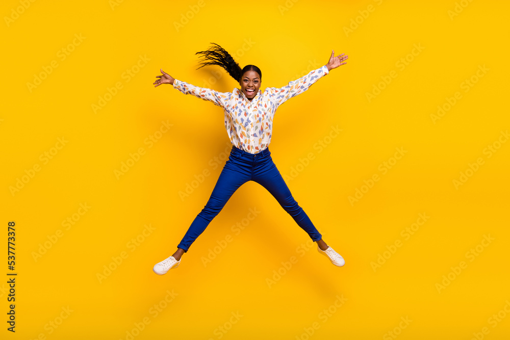 Full length body size view of attractive cheery crazy girl jumping having fun isolated over bright yellow color background