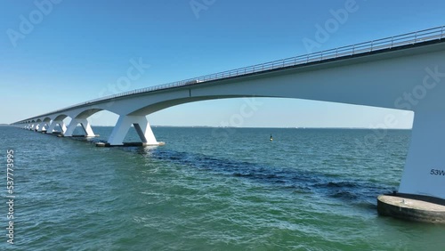 Zeelandbridge infinity bridge in the distance aerial drone view. part of Delta works. Dutch infrastructure holland Zeeland. Transporation delivery logisitics road. Overhead view. Holland. photo