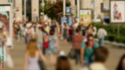 Wallpaper Mural A crowd of pedestrians and cyclists. People walk down a busy street with advertising, billboards, cars and public transport. Slow motion. Hot summer day. Torontodigital.ca
