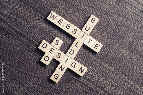 Conceptual media keywords on table with elements of game making crossword