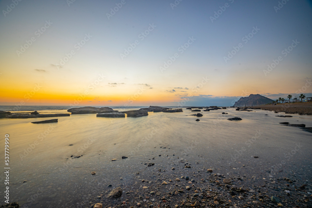 Obraz premium Beautiful seascape at sunset with rock formations in the water