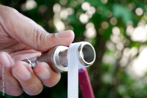 Wrap white tape on the tap to secure it.