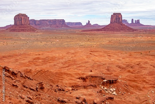 Towering sandstone buttes of Monument Valley Navajo Tribal Park under cloudy sky, Arizona photo