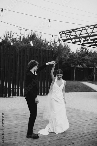 Young wedding couple dancing together on their own