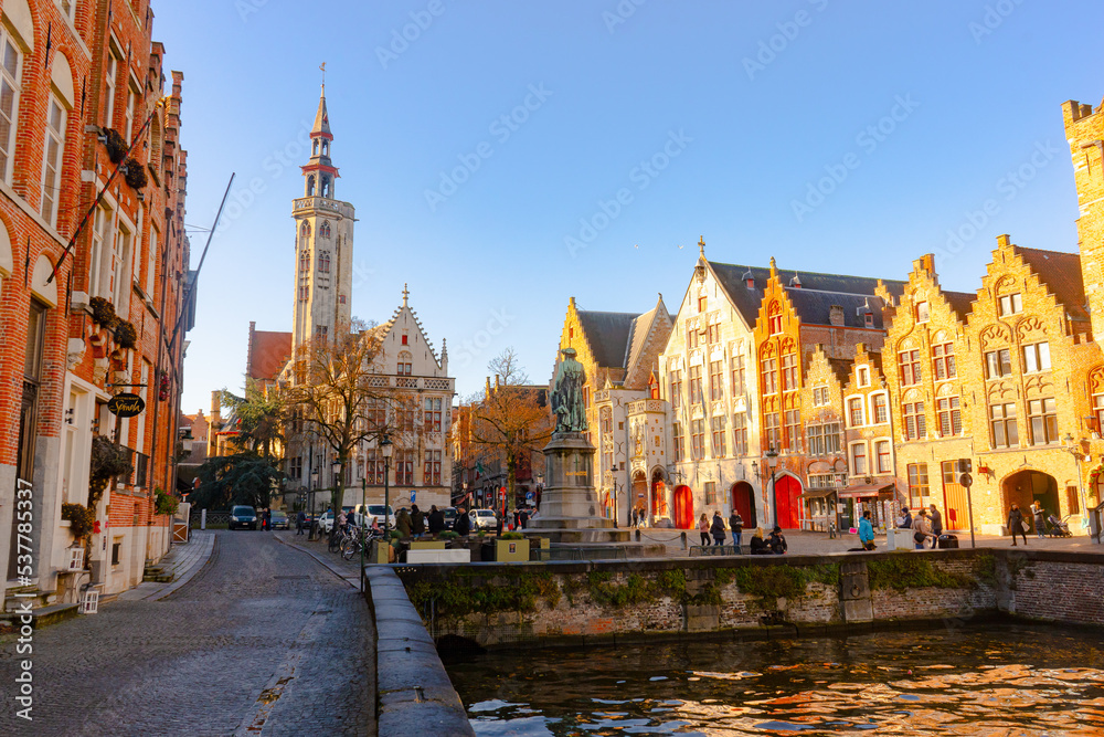Jan Van Eyck Square ,  located along the canals of Academiestraat, Spiegelrei and Spanjaardstraat in Brugge during winter sunny day : Brugge , Belgium : November 30 , 2019