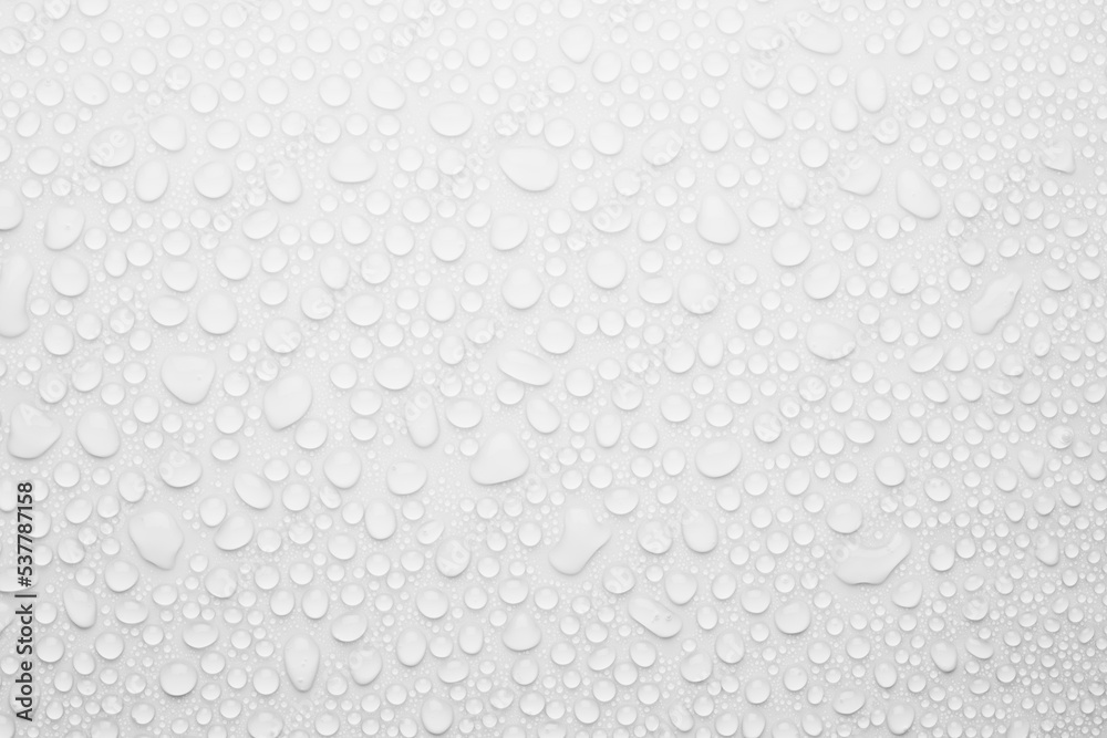 Soft light water droplets on white background as elegant simple fresh modern pattern with soft matte surface, top view.