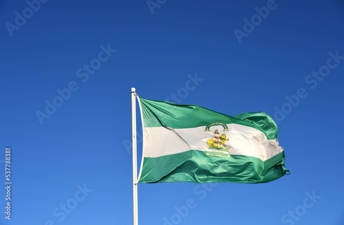 Andalusian flag with a blue sky