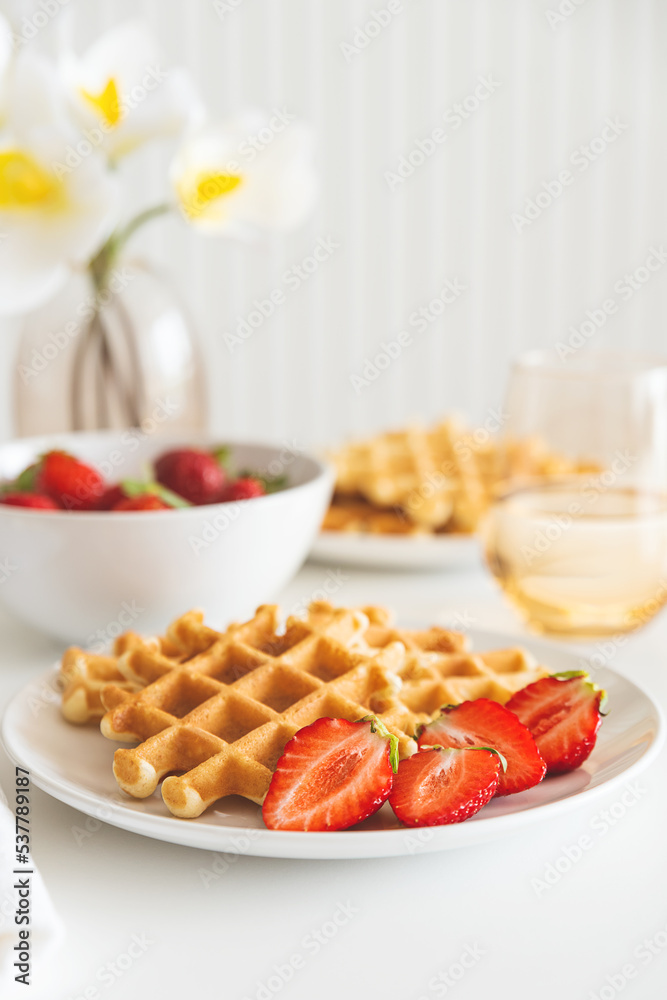 Belgian waffles with strawberry on white plate. Breakfast food concept