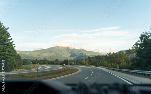 Driving a car on the highway with mountains in the background