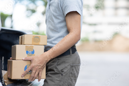 delivery man holding pile of cardboard boxes in front. copy space. © Witoon
