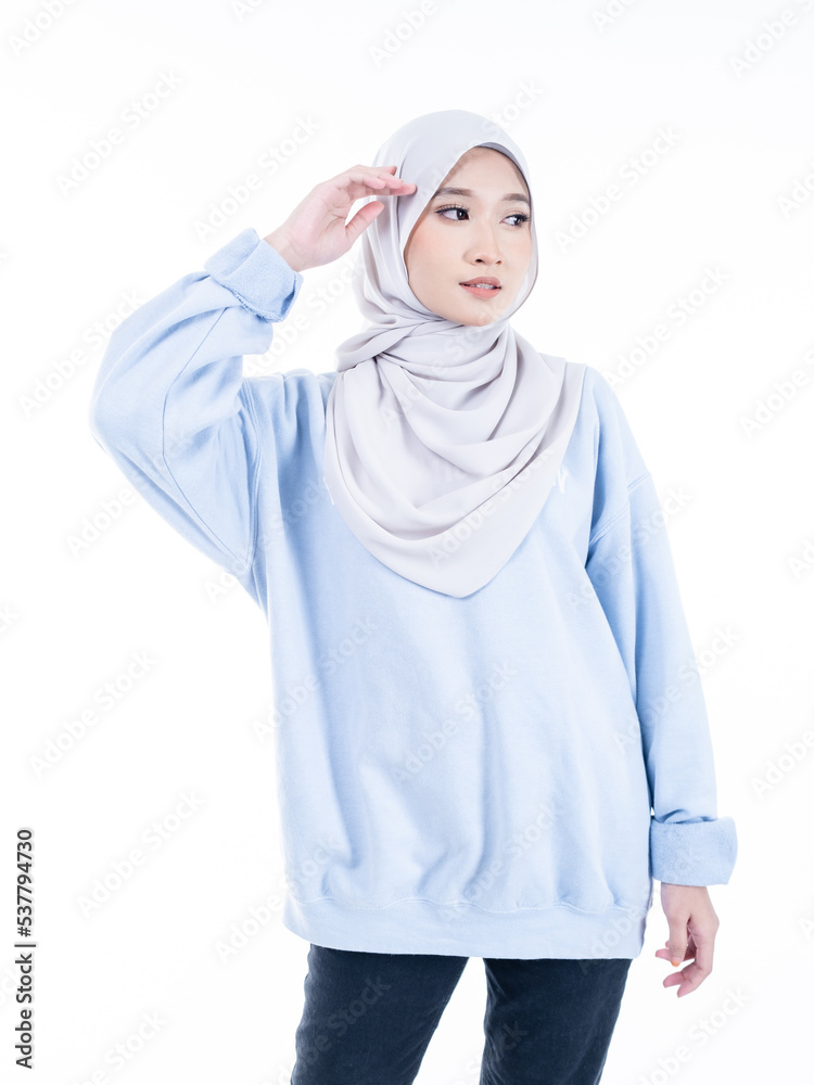 Portrait of a beautiful Muslim female model wearing modern and stylish casualwear with hijab isolated white studio background. Modern hijab fashion and beauty concept