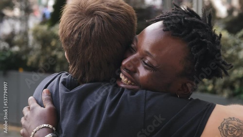 Stop racism: African American man and Caucasian man hug each other