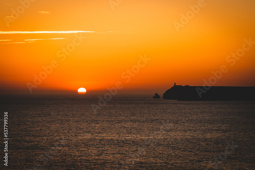 mystical sunset by the sea with a section of coast 