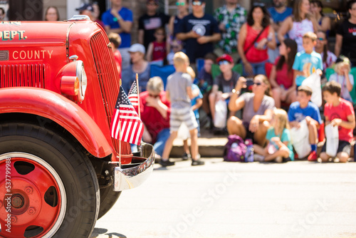 Small Town Fourth of July Parade, Vintage Firetruck with American Flags © Jenna Hidinger Photo