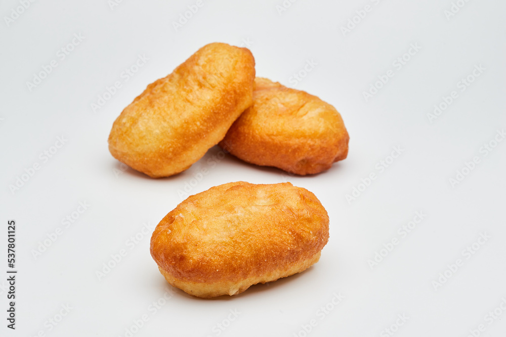 Tasty fried donuts isolated on white background. Unhealthy food. Studio shoot Tasty fried donuts isolated on white background. Unhealthy food. Studio shoot