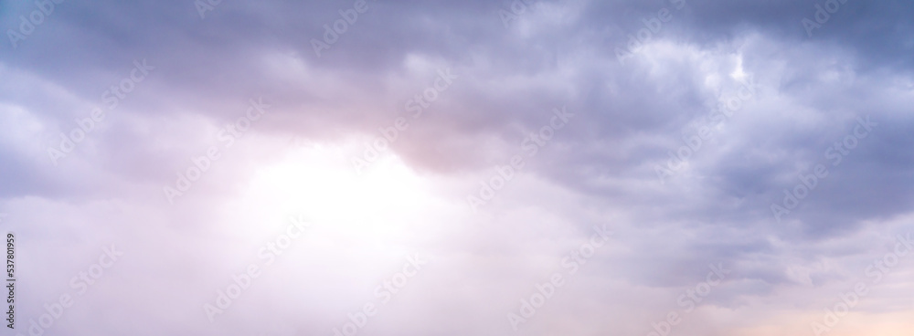Fototapeta premium The sun shines faintly through the gray and gloomy clouds