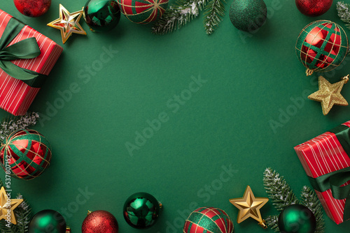 Christmas Eve concept. Top view photo of gift boxes with ribbon bows green red baubles gold star ornaments and pine branches on isolated green background with copyspace in the middle photo