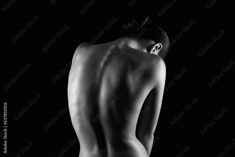 Nude silhouette of spine. Naked Woman. Beautiful Back. Black and white photo Nude silhouette of spine. Naked Woman. Beautiful Back. Black and white photo